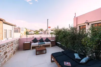 a balcony with couches and plants on a building at Serenissima Boutique Hotel in Chania Town