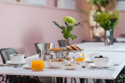 a table with breakfast foods and orange juice on it at Serenissima Boutique Hotel in Chania Town