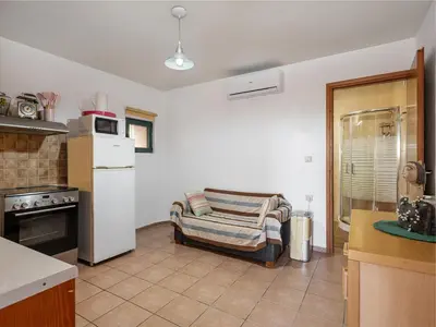 a kitchen with a refrigerator and a chair in it at The Hillside Home in Plataniás