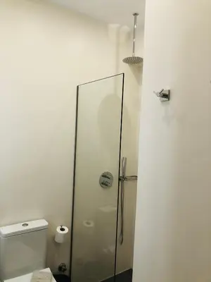 a bathroom with a glass shower with a toilet at Cloudberry in Kalyves