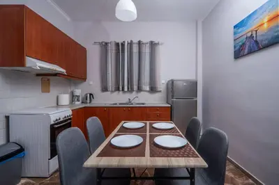 a kitchen with a table and chairs in a kitchen at Sea Gem family in Chania Town