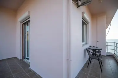 a chair on a balcony with a view of the ocean at Sea Gem family in Chania Town