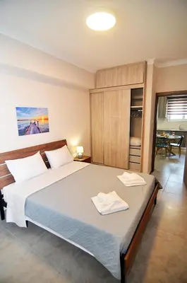 a bedroom with a large bed with two towels on it at eleftheria's apartment in Chania Town