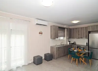 a kitchen with a table and chairs and a refrigerator at eleftheria's apartment in Chania Town