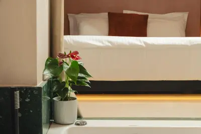 a bedroom with a bed and a potted plant on a table at D-Loft Chania in Chania Town