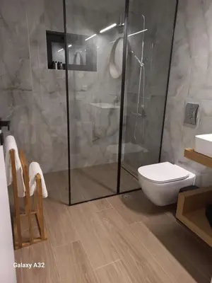 a bathroom with a toilet and a glass shower at Central City Loft by NEK in Chania Town