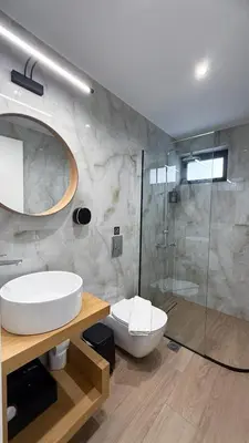 a bathroom with a toilet and a sink and a shower at Central City Loft by NEK in Chania Town