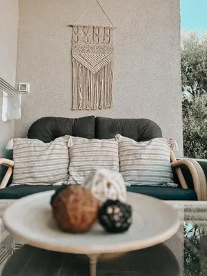 a living room with a table and a couch at Stella's Boho Retreat in Palaiochóra