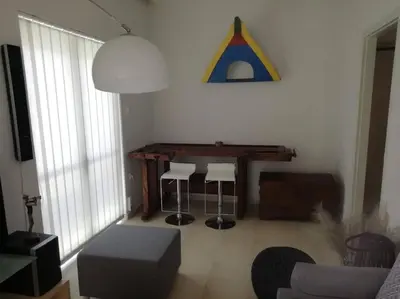 a living room with a wooden table and stools at Enjoy Chania in Chania Town