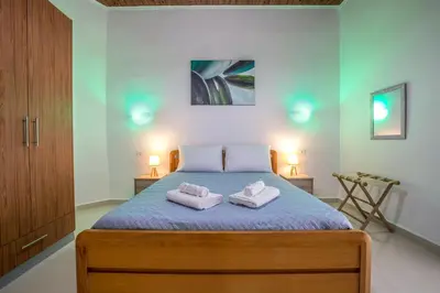 a bedroom with a bed with two towels on it at Kalyves Pearl apartments by the sea in Kalyves