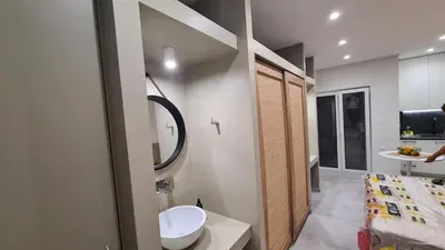 a bathroom with a sink and a toilet and a mirror at Cozy Studio in the Heart of Chania in Chania Town