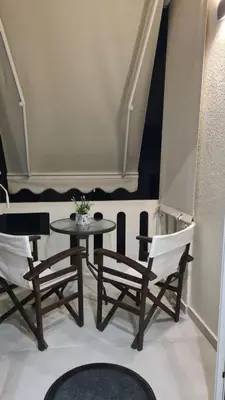 a table and chairs in a room with a window at Cozy Studio in the Heart of Chania in Chania Town