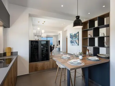 a kitchen with a table and a dining room at Alectrona Living Crete, Villa Ãcro in Plataniás