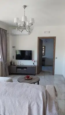a living room with a bed and a television at Ioanna Apartment 1 in Chania Town