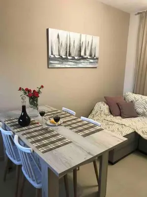 a dining room table with chairs and a table with wine glasses at Anastasia’s Home in Chania Town