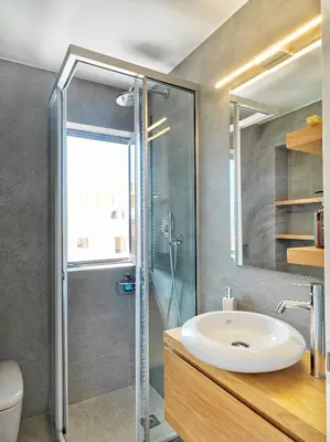 a bathroom with a sink and a shower at Alectrona Living Crete, Apartment Olīvea in Plataniás