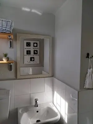 a bathroom with a sink and a microwave at Karel house in Karés