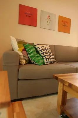 a living room with a couch with pillows on it at Horizonte Seafront Suites in Kissamos