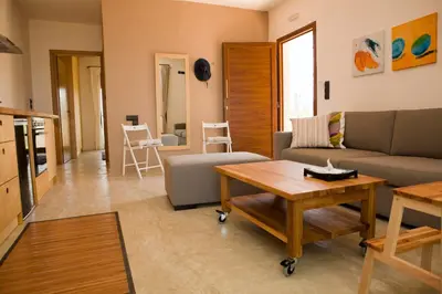 a living room with a couch and a table at Horizonte Seafront Suites in Kissamos