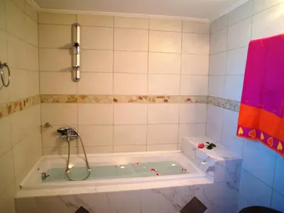 a bathroom with a tub with a shower at Mouri Villa in Mouríon