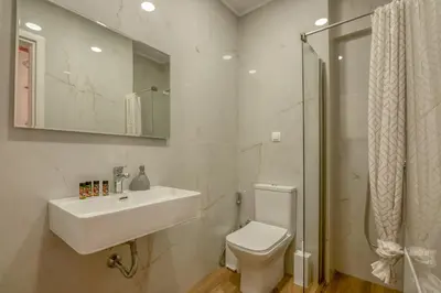 a bathroom with a sink and a toilet and a shower at Elma's Villa in Kissamos