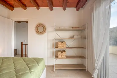 a bedroom with a bed and a book shelf at Elma's Villa in Kissamos