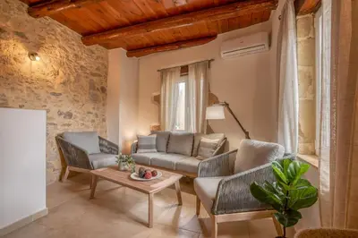 a living room with two chairs and a couch and a table at Elma's Villa in Kissamos