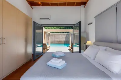 a bedroom with a bed with two towels on it at Unlimited Blue in Chania Town