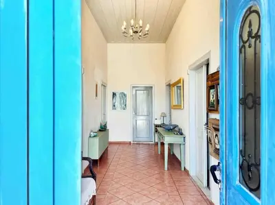 a hallway with a room with a table and a desk at Villa Xanthippe in Vamos