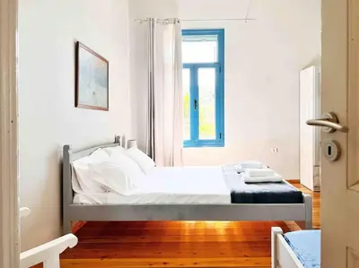 a bed in a room with a window at Villa Xanthippe in Vamos