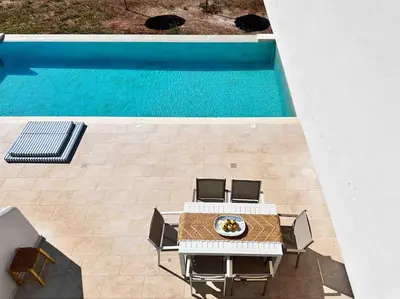 an overhead view of a table and chairs next to a pool at Villa Xanthippe in Vamos