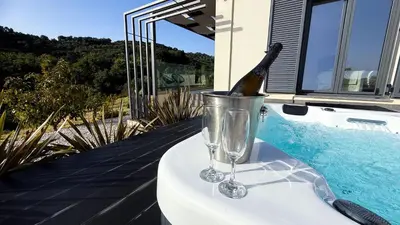 a bottle of champagne in a bucket next to a pool at Ek Ornelakis, Luxury Country House with Jacuzzi in Chania Town