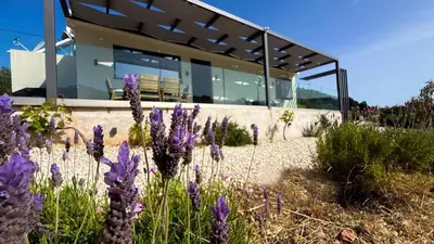 a house with purple flowers in front of it at Ek Ornelakis, Luxury Country House with Jacuzzi in Chania Town