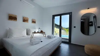 a bedroom with a bed with a mirror and a table at Ek Ornelakis, Luxury Country House with Jacuzzi in Chania Town