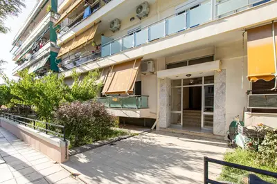 a building with a sidewalk in front of it at Neaira City Apartment Near The Beach in Chania Town