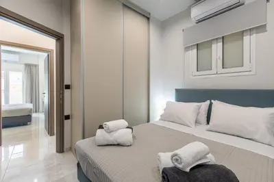 a bedroom with a bed with towels on it at Neaira City Apartment Near The Beach in Chania Town