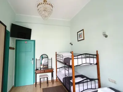 a room with two bunk beds and a chandelier at The blackbird's nest in Chania Town