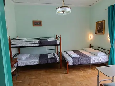 a room with two bunk beds and a table at The blackbird's nest in Chania Town