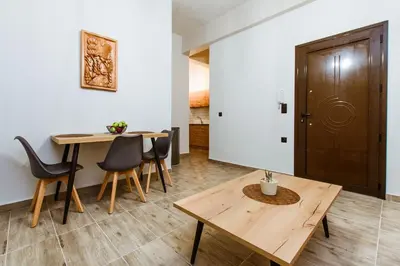 a dining room with a wooden table and chairs at Krinis houses next the old harbour in Chania Town