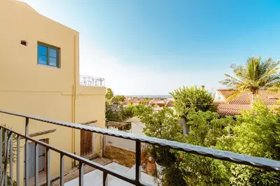 a balcony with a view of a building at Krinis houses next the old harbour in Chania Town