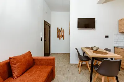 a living room with a couch and a table at Krinis houses next the old harbour in Chania Town