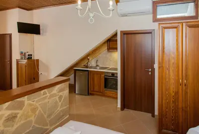 a kitchen with a staircase with a sink and a stove at Pleiades Apartments in Chania Town