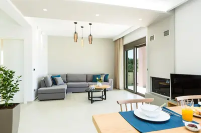 a living room with a couch and a table at Estel Residences in Chania Town