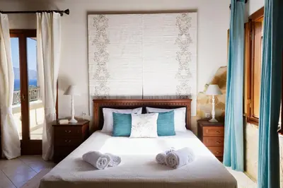 a bedroom with a bed with towels on it at Patriko Villa in Kissamos