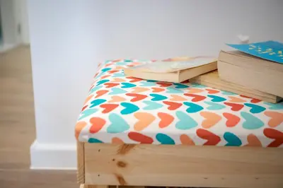 a bed with books sitting on top of it at Little gem by the sea in Chania Town