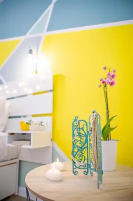 a room with a table and a yellow wall at Oasis by the sea in Chania Town
