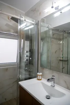 a bathroom with a sink and a shower at EDEL Suite in Chania Town