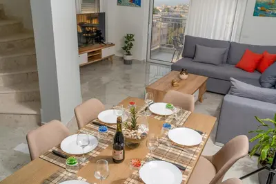 a living room with a table and chairs and a couch at EDEL Suite in Chania Town