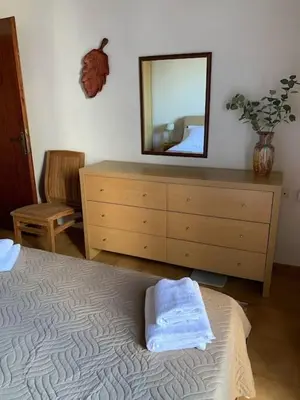 a bedroom with a bed and a dresser with a mirror at Stelios house in Chania Town