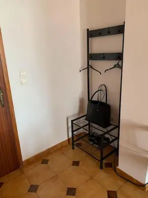 a room with a black stand with a bag on it at Stelios house in Chania Town